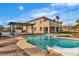 A backyard featuring a large in-ground pool with a slide, a covered patio and a basketball court at 6214 Ebony Legends Ave, Las Vegas, NV 89131