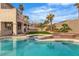 A serene pool area with a built-in spa and lush landscaping, perfect for relaxation at 6214 Ebony Legends Ave, Las Vegas, NV 89131
