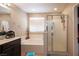Bright bathroom offers a bath tub, shower and white cabinets at 6487 W Levi Ave, Las Vegas, NV 89141