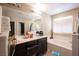 Bright bathroom with double vanity, bathtub and white cabinets at 6487 W Levi Ave, Las Vegas, NV 89141