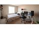 Bedroom features a comfortable bed, desk, and natural light from the window at 6487 W Levi Ave, Las Vegas, NV 89141
