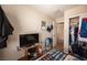 Bedroom with closet, TV, and staircase access, offering comfort and convenience at 6487 W Levi Ave, Las Vegas, NV 89141