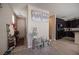 Bright entryway with wood-look flooring, modern decor, and convenient access to kitchen and staircase at 6487 W Levi Ave, Las Vegas, NV 89141