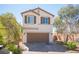 Charming two-story home featuring a two-car garage, desert landscaping, and a classic stucco exterior with brown shutters at 6487 W Levi Ave, Las Vegas, NV 89141