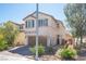Two-story home with neutral stucco, two-car garage, and tidy desert landscaping for low-maintenance curb appeal at 6487 W Levi Ave, Las Vegas, NV 89141