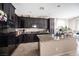 Open kitchen featuring granite countertops and dark cabinetry at 6487 W Levi Ave, Las Vegas, NV 89141