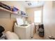 Functional laundry room with modern appliances and storage shelves at 6487 W Levi Ave, Las Vegas, NV 89141