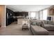 Inviting living space featuring dark cabinets, breakfast bar, gray plank floors, and ample natural light at 6487 W Levi Ave, Las Vegas, NV 89141