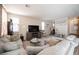 Spacious living room with comfortable seating, gray plank flooring, and plenty of natural light at 6487 W Levi Ave, Las Vegas, NV 89141