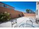 A simple outdoor patio featuring a brick wall, a grill and a clear blue sky at 6487 W Levi Ave, Las Vegas, NV 89141