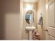 Well-lit powder room with pedestal sink and decorative mirror at 6487 W Levi Ave, Las Vegas, NV 89141