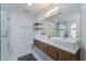 Modern bathroom features double sinks, wood cabinets, sleek fixtures, and a glass shower at 6727 Enchanted Cove Ct, Las Vegas, NV 89139