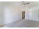 Spacious bedroom features a ceiling fan, closet with sliding doors and carpeted floors at 6727 Enchanted Cove Ct, Las Vegas, NV 89139