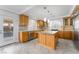 Light-filled kitchen includes stainless appliances, wood cabinets and access to a pool at 6727 Enchanted Cove Ct, Las Vegas, NV 89139