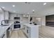 Well-lit kitchen features stainless steel appliances, an island, and an open concept layout at 71 Sea Holly Way, Henderson, NV 89074