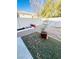 Backyard with a gravel area, garden boxes, artificial turf, and privacy fence at 8036 Maple Park St, Las Vegas, NV 89131