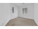 A basic bedroom with carpeted floor, two windows, and light colored walls at 8036 Maple Park St, Las Vegas, NV 89131
