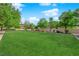 Community common area featuring a large manicured lawn with beautiful mature trees at 8036 Maple Park St, Las Vegas, NV 89131