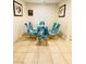 Cozy dining room with a modern table, six chairs, neutral wall paint, and tile flooring at 8036 Maple Park St, Las Vegas, NV 89131