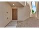 Front entry with a brown door, concrete walkway and neutral colored stucco at 8036 Maple Park St, Las Vegas, NV 89131