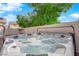 Backyard featuring a hot tub, privacy fence, patio and artificial turf at 8036 Maple Park St, Las Vegas, NV 89131
