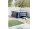Backyard with a gravel area, privacy fence, artificial turf, and hot tub at 8036 Maple Park St, Las Vegas, NV 89131