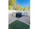 Backyard with a gravel area, privacy fence, artificial turf, and hot tub at 8036 Maple Park St, Las Vegas, NV 89131