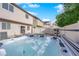 Backyard featuring a hot tub, privacy fence, patio and artificial turf at 8036 Maple Park St, Las Vegas, NV 89131