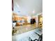 Open kitchen with granite counters, wood cabinets, an island with seating at 8036 Maple Park St, Las Vegas, NV 89131