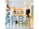 Large kitchen featuring light wood cabinets, an island, and breakfast bar at 8036 Maple Park St, Las Vegas, NV 89131