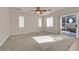 Bright living room featuring neutral walls, plush carpet, and sliding glass doors to the backyard at 8036 Maple Park St, Las Vegas, NV 89131