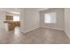 Open-concept living room with tile flooring near the kitchen and natural light at 8036 Maple Park St, Las Vegas, NV 89131