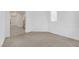 A bright living room features neutral carpet, white walls, and a window for natural light at 8036 Maple Park St, Las Vegas, NV 89131