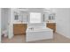 Large main bathroom with bathtub, dual sinks and bright lighting at 8036 Maple Park St, Las Vegas, NV 89131
