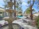 Relaxing backyard with a decorative fountain, stone bench, and mature trees at 8112 Golfers Oasis Dr, Las Vegas, NV 89149