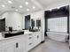 Modern bathroom featuring dual sinks, soaking tub, and glass block accent wall at 8112 Golfers Oasis Dr, Las Vegas, NV 89149