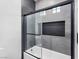 Modern bathroom featuring a glass-enclosed shower and built in shelving at 8112 Golfers Oasis Dr, Las Vegas, NV 89149