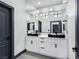 Sleek bathroom featuring double sinks with vessel basins, modern lighting, and dark hardware at 8112 Golfers Oasis Dr, Las Vegas, NV 89149