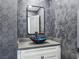 Modern bathroom featuring a vessel sink, hexagon tile wall and rectangular mirror at 8112 Golfers Oasis Dr, Las Vegas, NV 89149