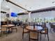 Elegant dining area with dark wood trim, a bar, large windows, and seating for large and small groups at 8112 Golfers Oasis Dr, Las Vegas, NV 89149