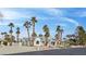 Inviting single-story home with lush palm trees and meticulous desert landscaping at 8112 Golfers Oasis Dr, Las Vegas, NV 89149