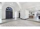 Open concept home with a bright foyer, arched doorway, and view into the kitchen at 8112 Golfers Oasis Dr, Las Vegas, NV 89149