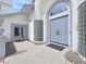 A grand front door with glass block accents, framed by neutral colors and manicured landscaping at 8112 Golfers Oasis Dr, Las Vegas, NV 89149