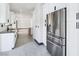Long view of the modern kitchen featuring a stainless steel fridge and ample counter space at 8112 Golfers Oasis Dr, Las Vegas, NV 89149
