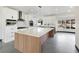 Bright kitchen with stainless appliances, white cabinets and view to outdoor patio at 8112 Golfers Oasis Dr, Las Vegas, NV 89149
