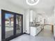 View of the kitchen connecting with outside pool through french doors at 8112 Golfers Oasis Dr, Las Vegas, NV 89149