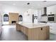 Modern kitchen with stainless appliances, large island and view to the fireplace wall at 8112 Golfers Oasis Dr, Las Vegas, NV 89149