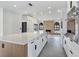 Open kitchen and living space with a large island and fireplace at 8112 Golfers Oasis Dr, Las Vegas, NV 89149