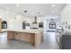 Bright kitchen with modern appliances, spacious island and view of the dining area at 8112 Golfers Oasis Dr, Las Vegas, NV 89149