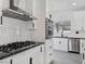 Stylish kitchen with stainless steel appliances, gas range, and sleek white cabinets with modern hardware at 8112 Golfers Oasis Dr, Las Vegas, NV 89149